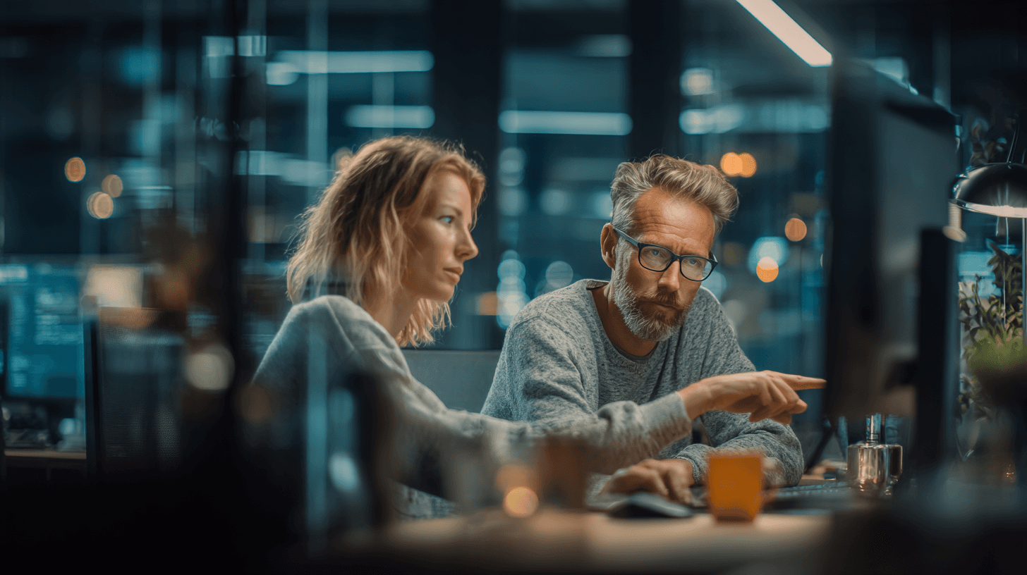 u2844336958 Two colleagues sitting side-by-side at adjacent d 8a736306-a96e-45a4-9ee6-ce1345680be6 3